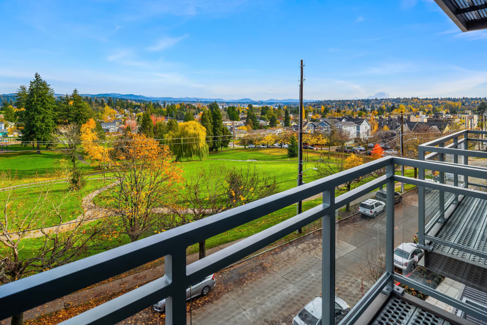 Spacious park view from apartment balcony at Cubix at Othello in Seattle, Washington 