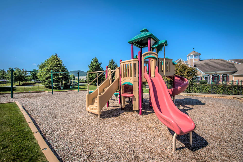 Onsite children's playground with a slide and more at Eagle Rock Apartments at Fishkill in Fishkill, New York