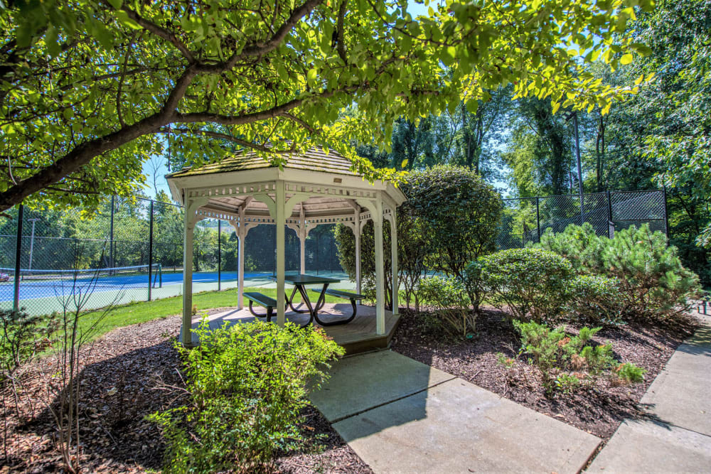 Serene courtyard with a gazebo and lush landscaping at Eagle Rock Apartments at Fishkill in Fishkill, New York