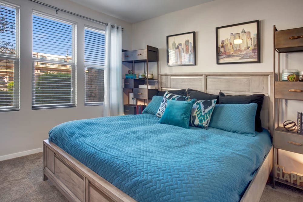 Bedroom with large windows at Luxe Scottsdale Apartments in Scottsdale, Arizona