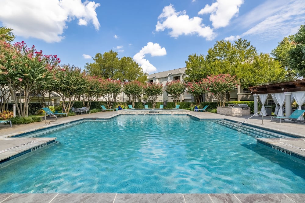 Pool with private cabanas and clubhouse at Marquis at Stonegate in Fort Worth, Texas