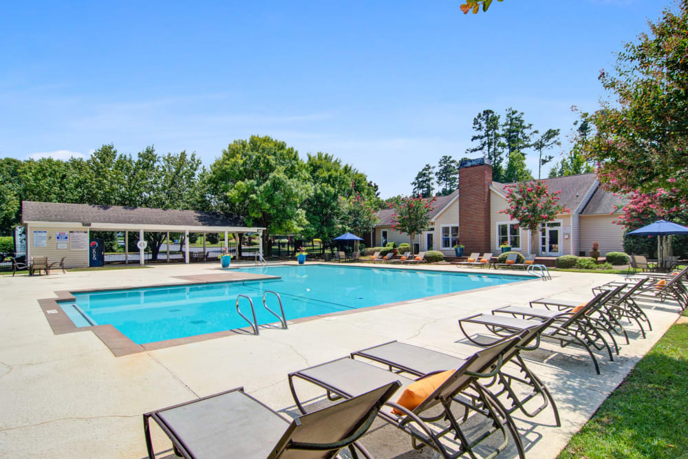 View of the glistening outdoor pool at Amber Chase Apartment Homes in McDonough, Georgia