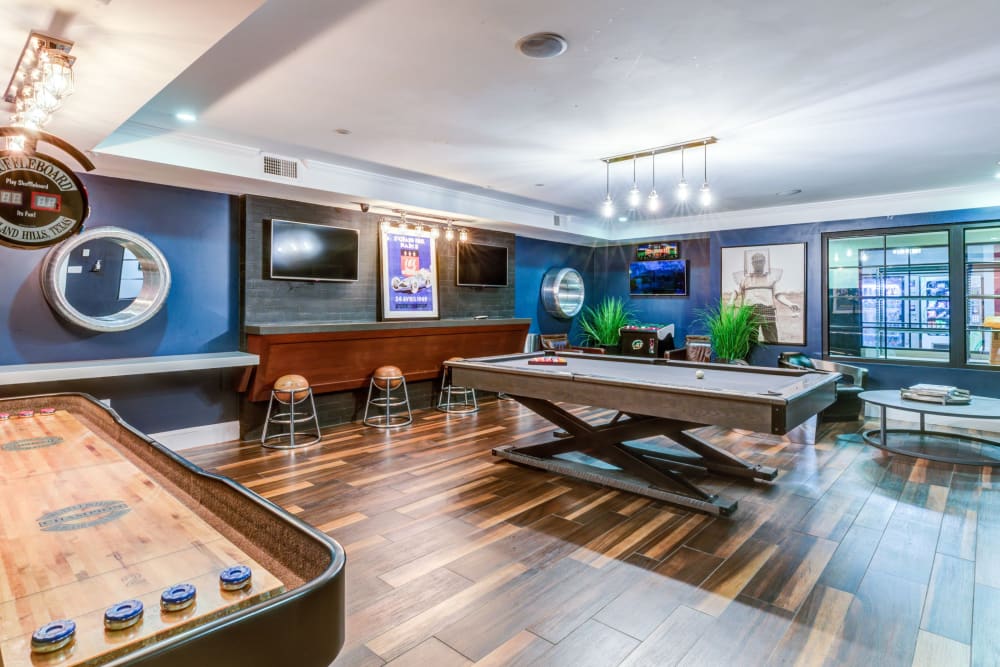 Shuffleboard and pool table in Clubhouse at Bradlee Danvers in Danvers, Massachusetts