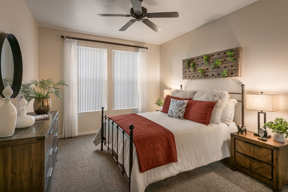 Large Primary bedroom with ceiling fan and beautiful furnishings in model home at San Norterra in Phoenix, Arizona