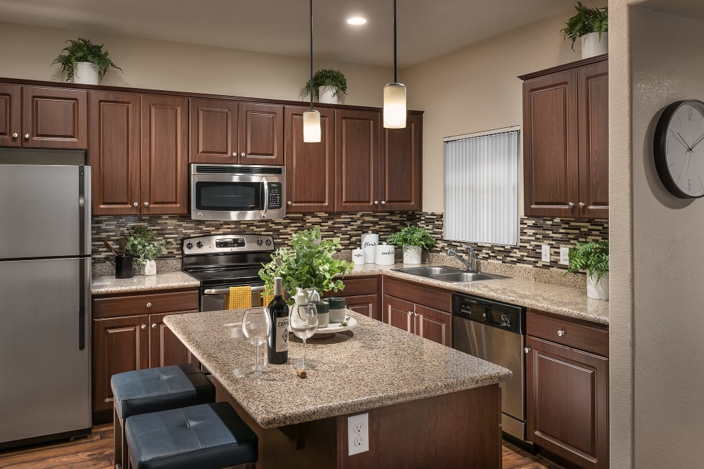 Gourmet kitchen with granite countertops and an island at San Norterra in Phoenix, Arizona