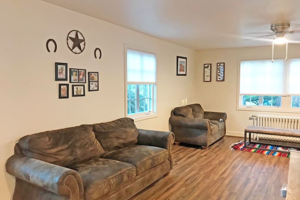 A living room with wood flooring in a home at The Bricks in Joint Base Lewis-McChord, Washington