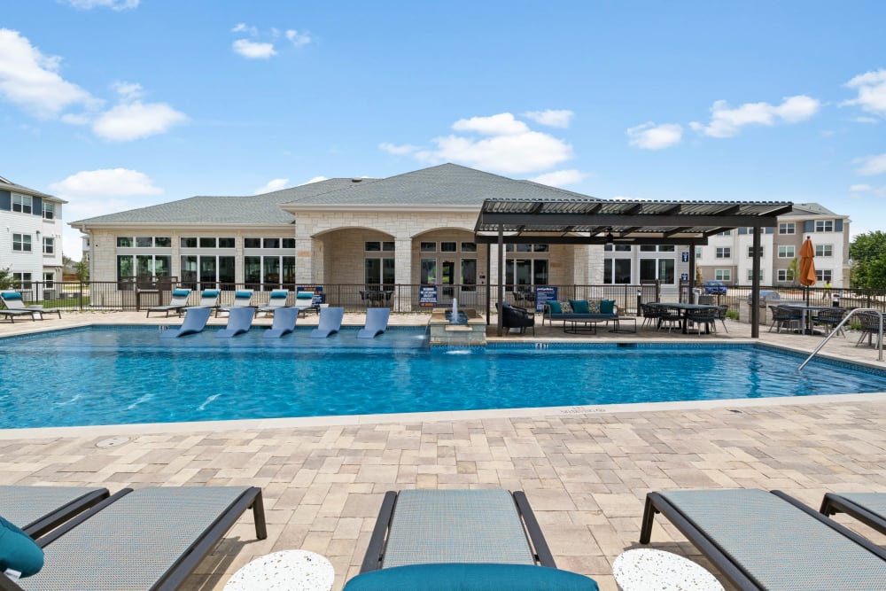 Sparkling pool and lounge chairs at Linden Ranch in Sachse, Texas