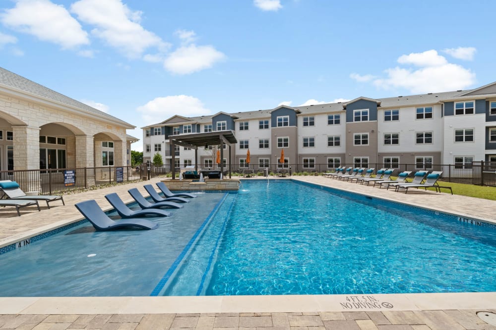 Pool with chaise lounges at Linden Ranch in Sachse, Texas