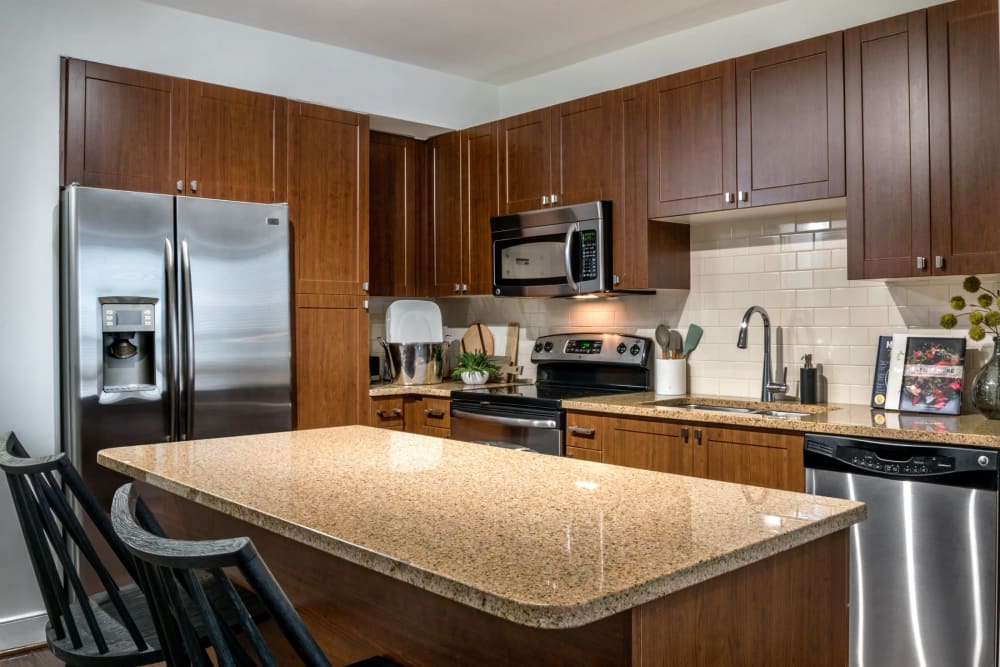 Huge island in the kitchen with granite style counters at Sofi 55 Hundred in Arlington, Virginia