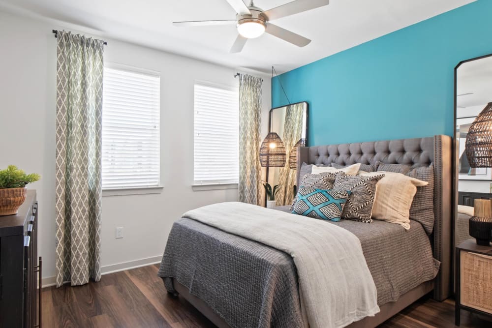 Model bedroom with large windows at 32Hundred Windsor in Denton, Texas