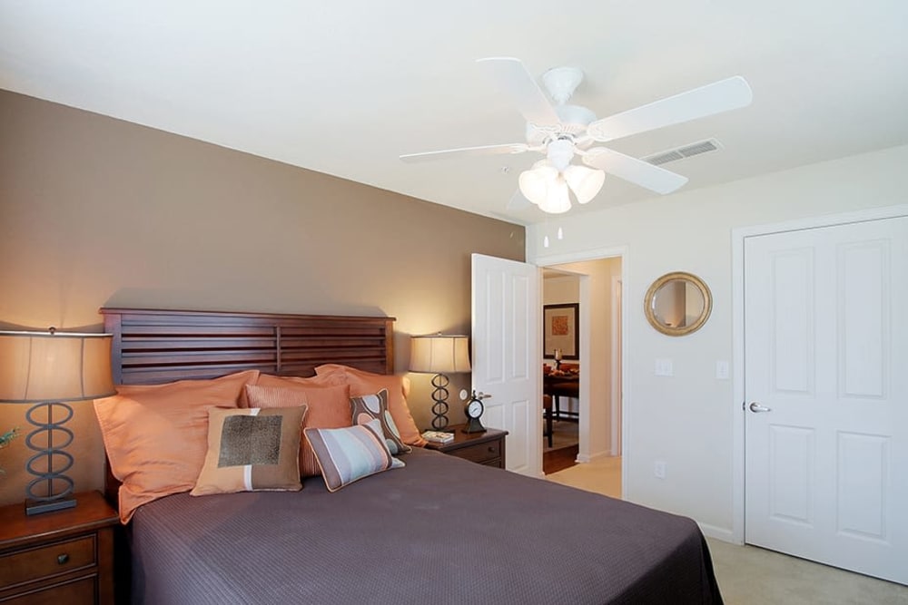 Model bedroom with a ceiling fan and walk-in closet at Parc at Flowing Wells Apartment Homes in Augusta, Georgia