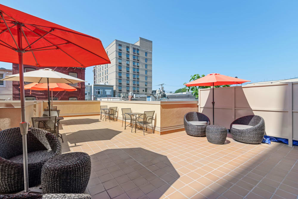 Shaded seating on rooftop lounge at ONE23 Apartments in Union City, New Jersey