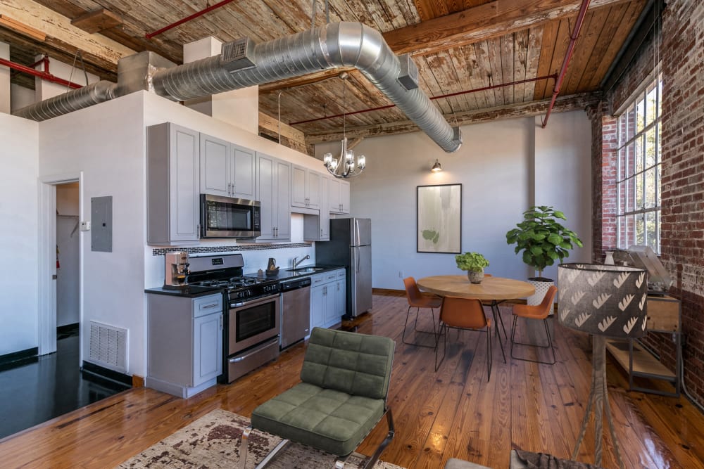 Model loft's kitchen with stainless-steel appliances at Brumby Lofts in Marietta, Georgia