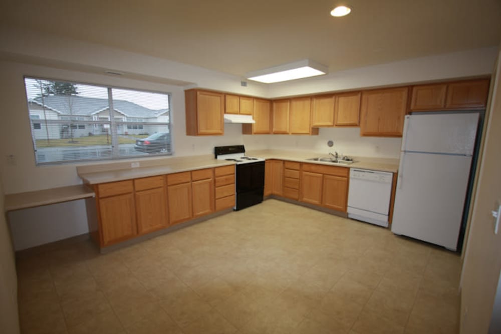 Kitchen with appliances in a home at Hillside in Joint Base Lewis-McChord, Washington