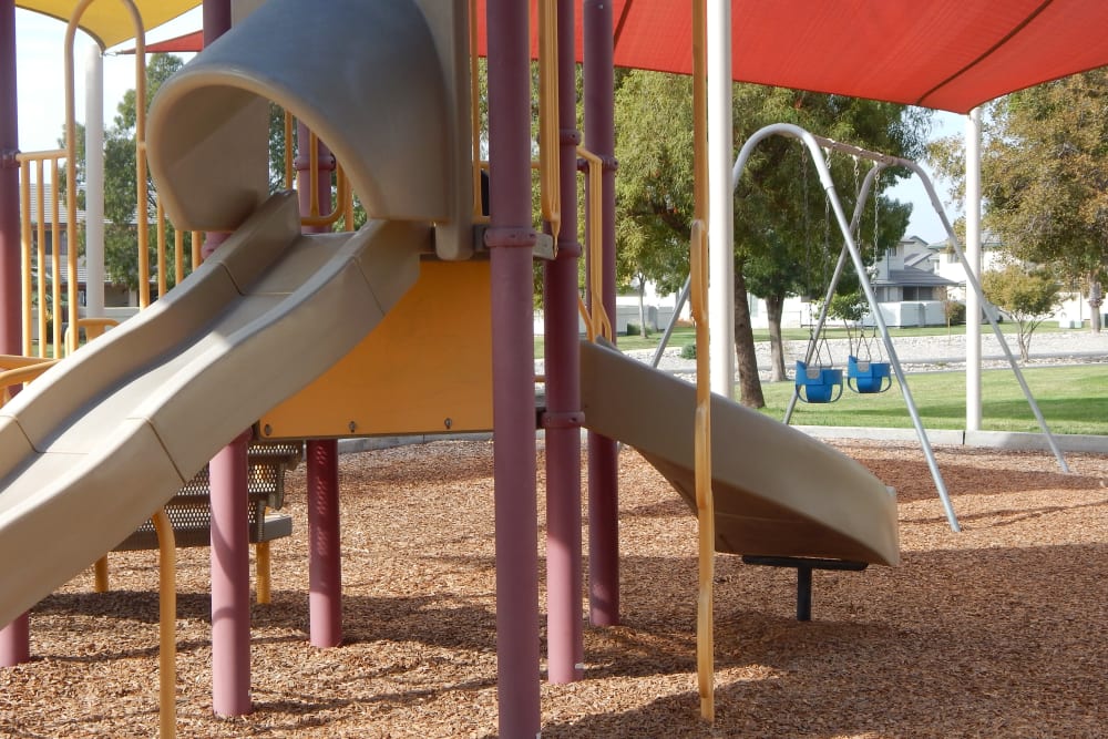 A shaded playground at Midway Park in Lemoore, California