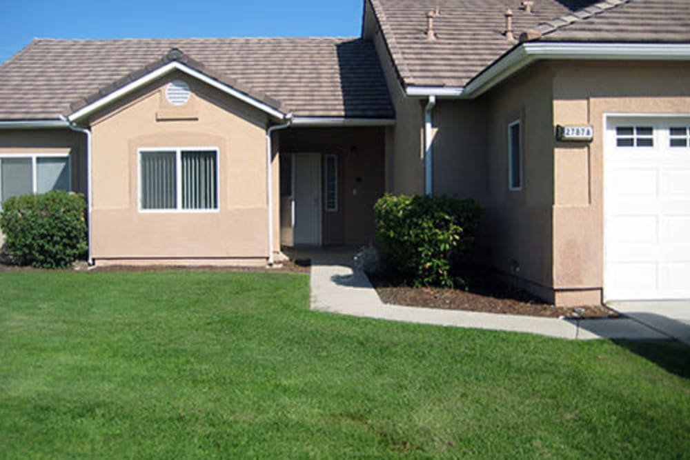 View of front lawn and walkway to a home at Midway Park in Lemoore, California