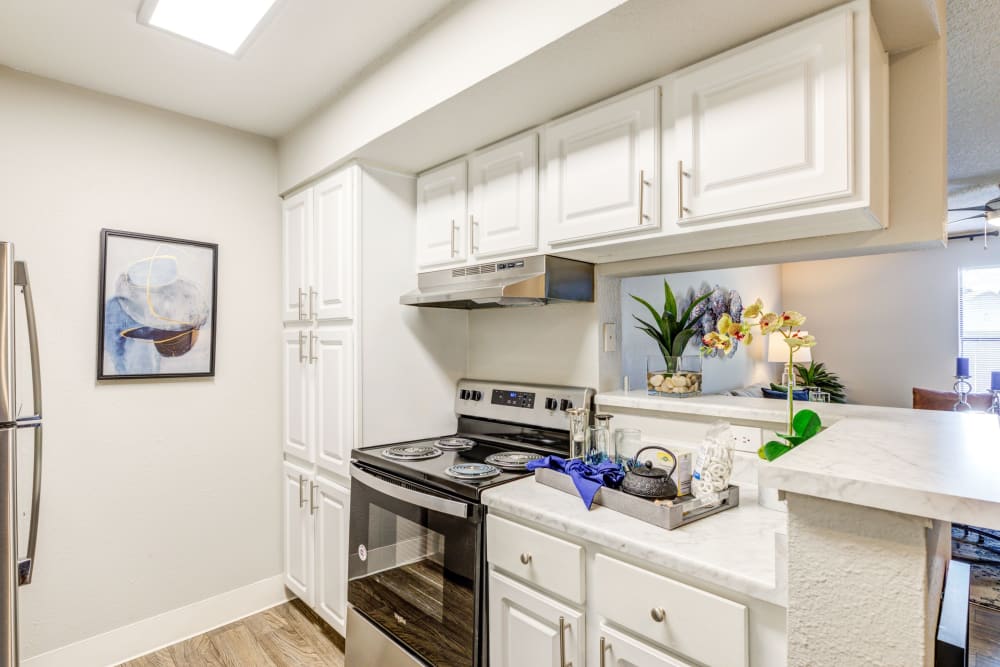 Kitchen with white cabinetry at Skyline in Thornton, Colorado