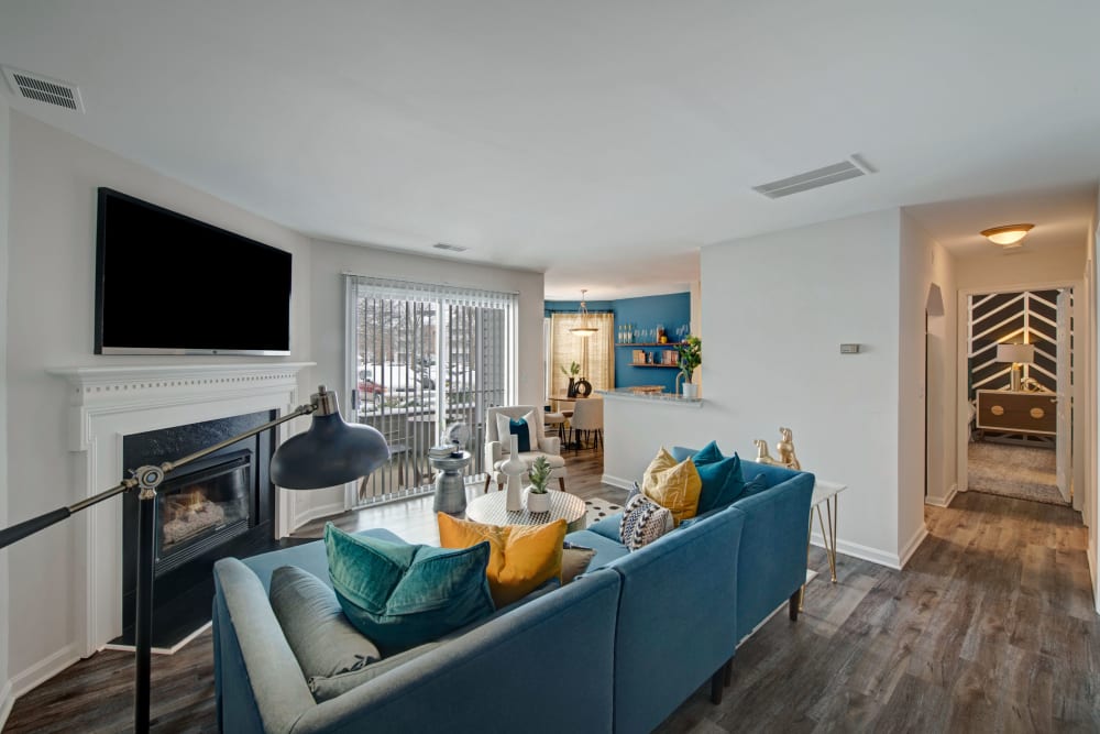 Model living room with fireplace and TV at Sussex at Kingstowne in Alexandria, Virginia