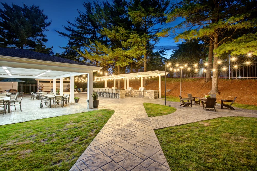 Outdoor barbecue area at night at The Hamptons at Town Center in Germantown, Maryland