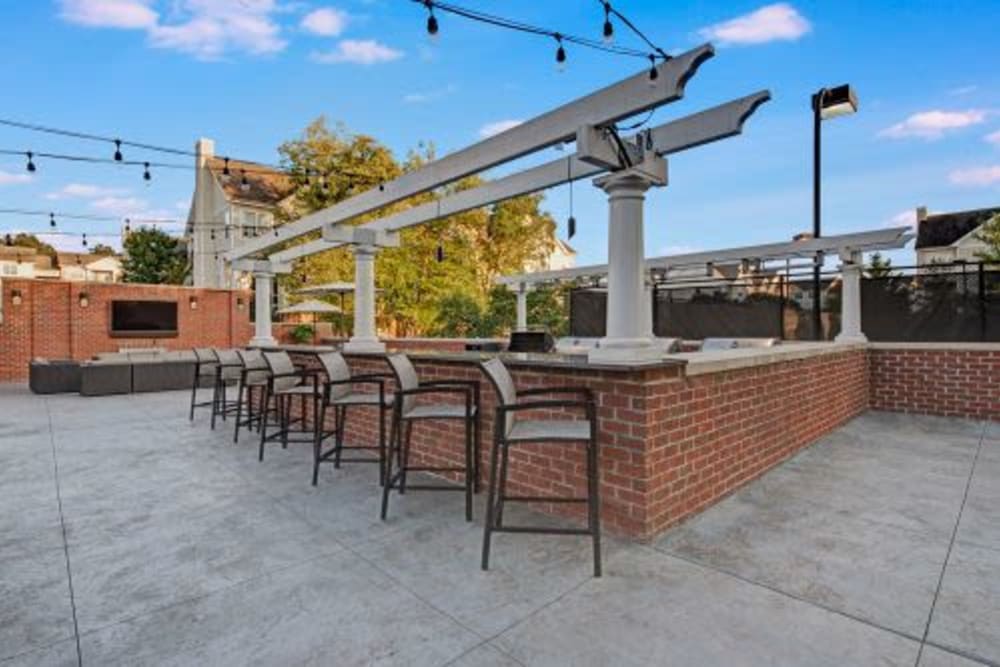 Bar seating near the outdoor barbecue area at Dulles Greene in Herndon, Virginia