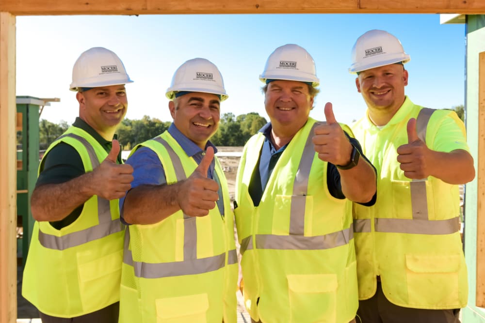 Construction workers giving a thumbs up at Blossom Ridge in Oakland Charter Township, Michigan