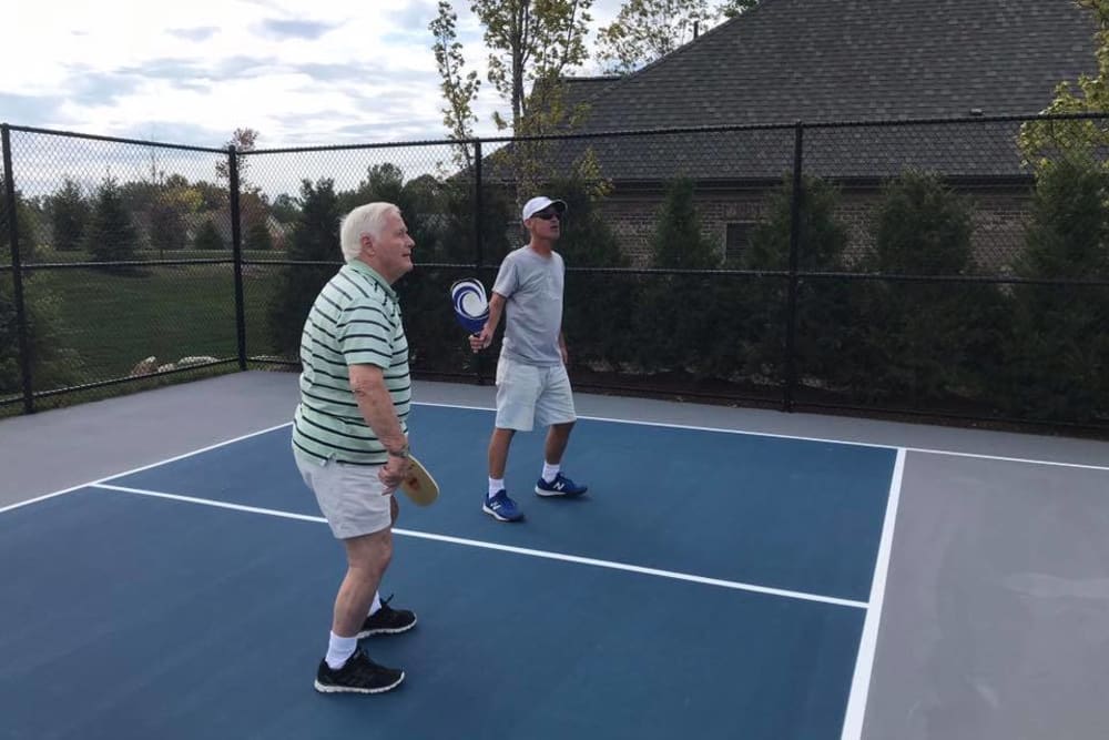 Residents standing on a pickleball court at Blossom Ridge in Oakland Charter Township, Michigan