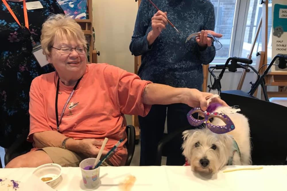 Resident petting a dog at Blossom Ridge in Oakland Charter Township, Michigan