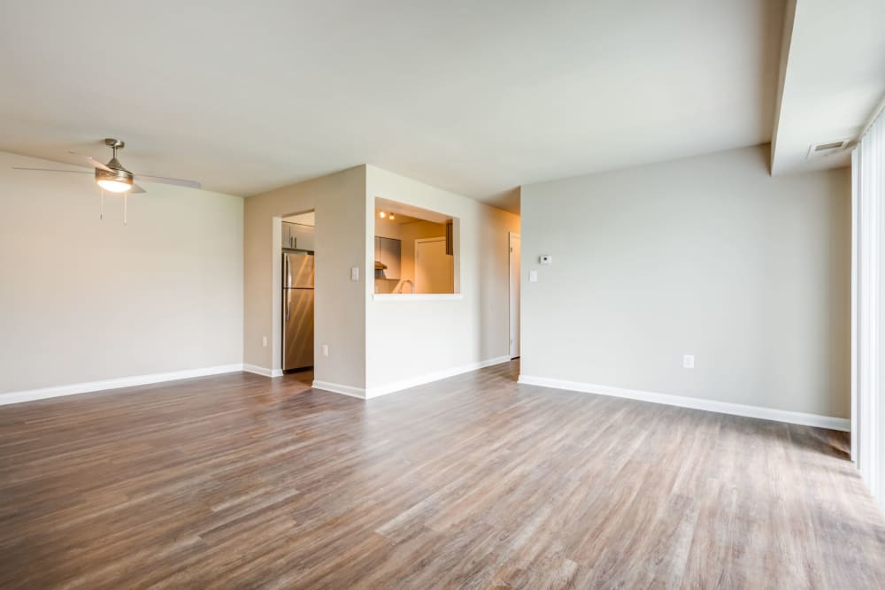 Empty model living room with laminate wood floors at The Landings I & II Apartments in Alexandria, Virginia