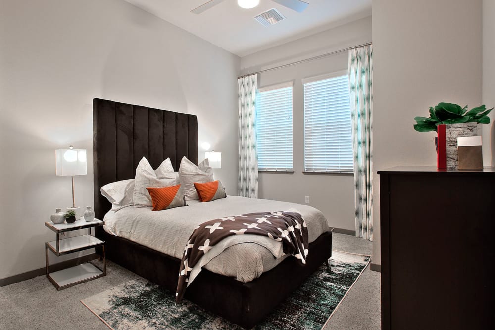 Beautifully furnished primary bedroom in a model apartment at Jade Apartments in Las Vegas, Nevada