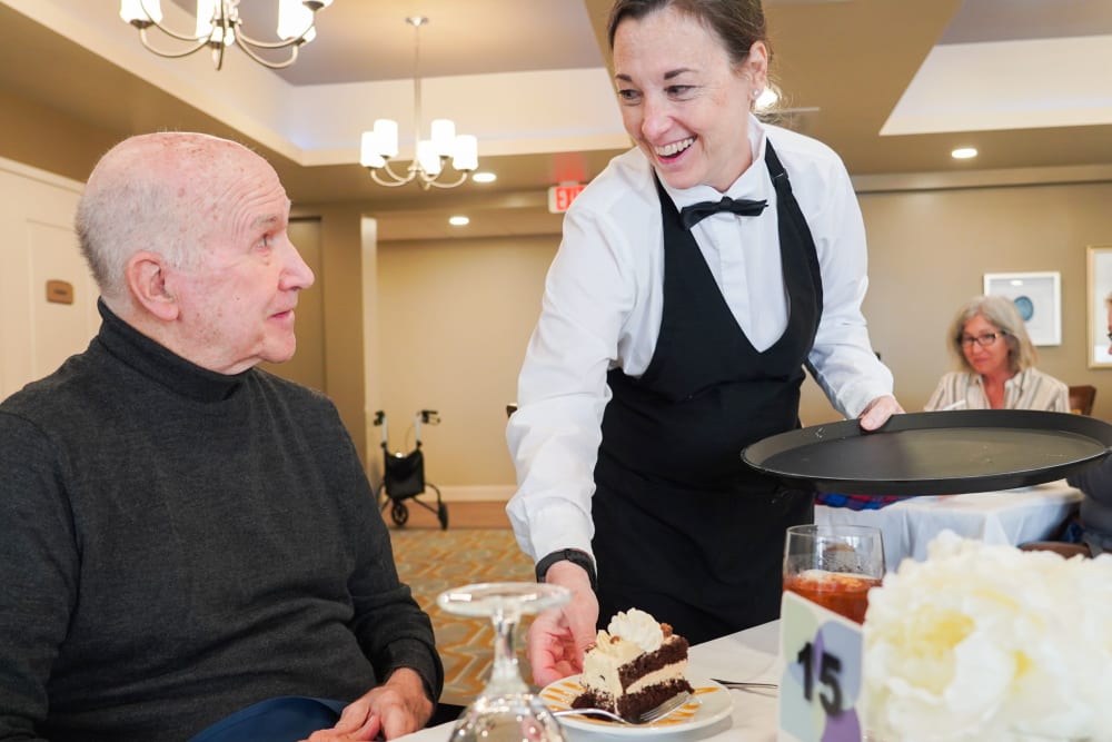 Resident being served dessert at Harmony at Harts Run in Glenshaw, Pennsylvania