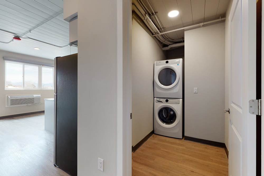 Laundry room with in unit laundry machines at Art District Flats in Denver, Colorado