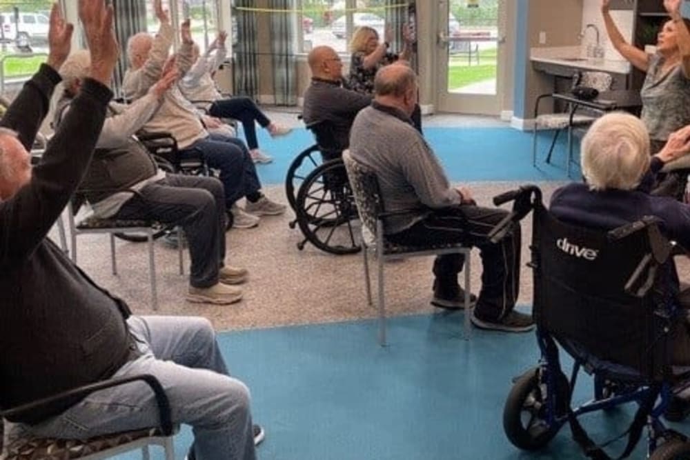 Residents at Blossom Springs during a fun chair exercise to keep those muscles moving.