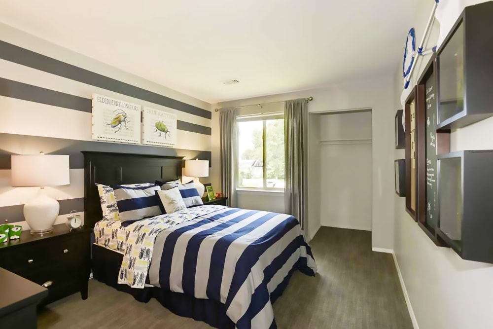 Fully furnished model bedroom with closet space at Satyr Hill Apartments in Parkville, Maryland