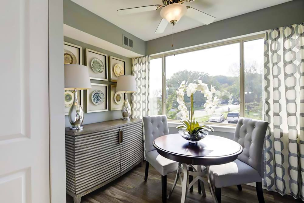 Model dining nook with large window at Satyr Hill Apartments in Parkville, Maryland