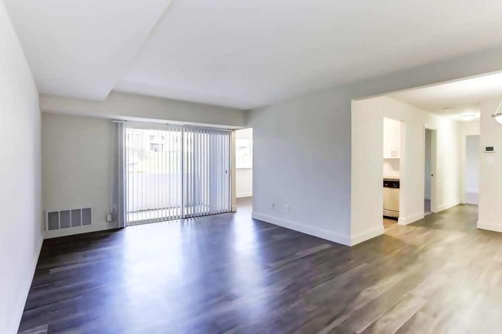 View of spacious living room unfurnished with hardwood flooring at Satyr Hill Apartments in Parkville, Maryland