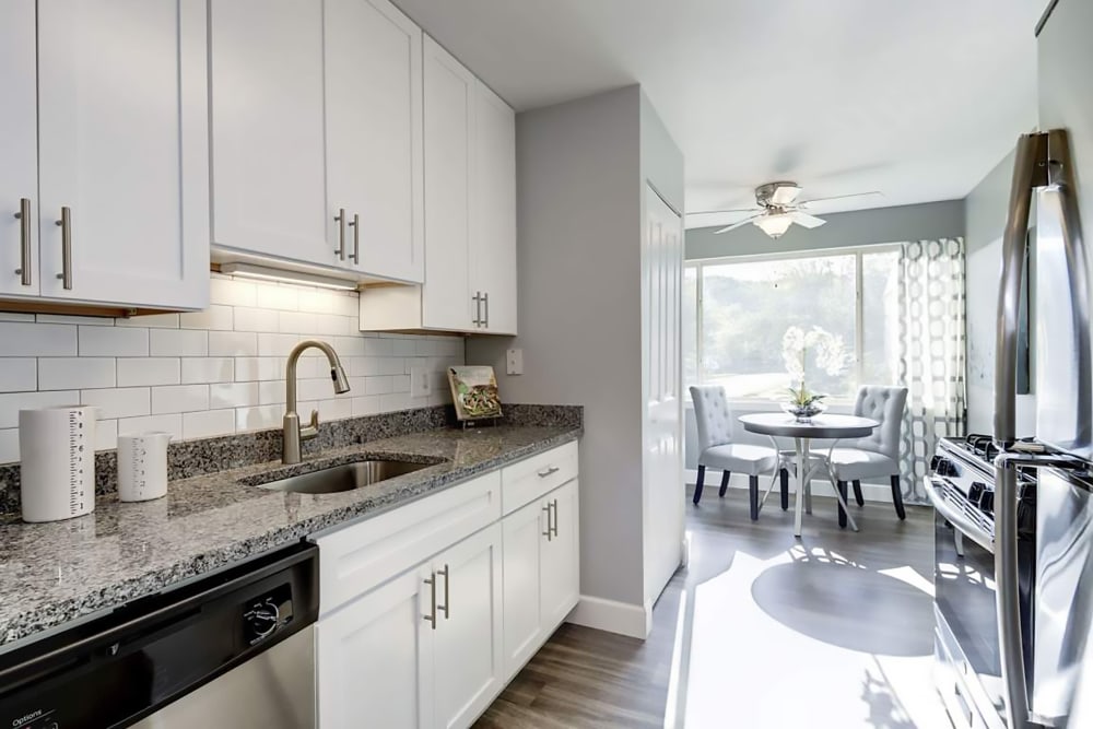 Beautiful model kitchen with granite countertops at Satyr Hill Apartments in Parkville, Maryland