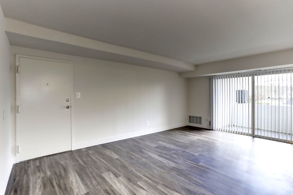 Unfurnished living room with hardwood style flooring at Satyr Hill Apartments in Parkville, Maryland