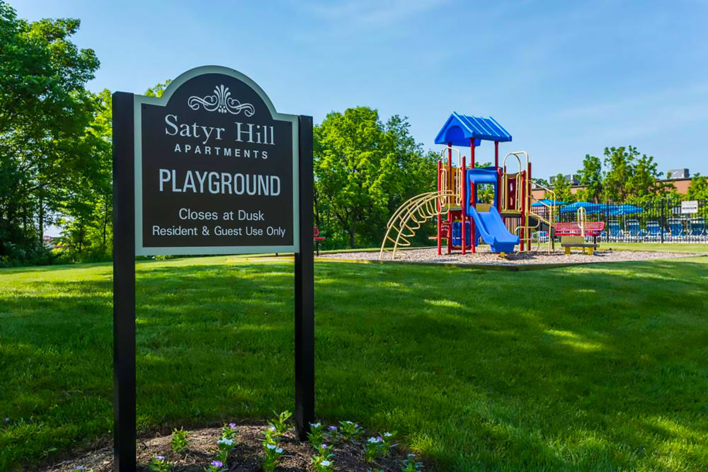 Community playground and green lawn at Satyr Hill Apartments in Parkville, Maryland