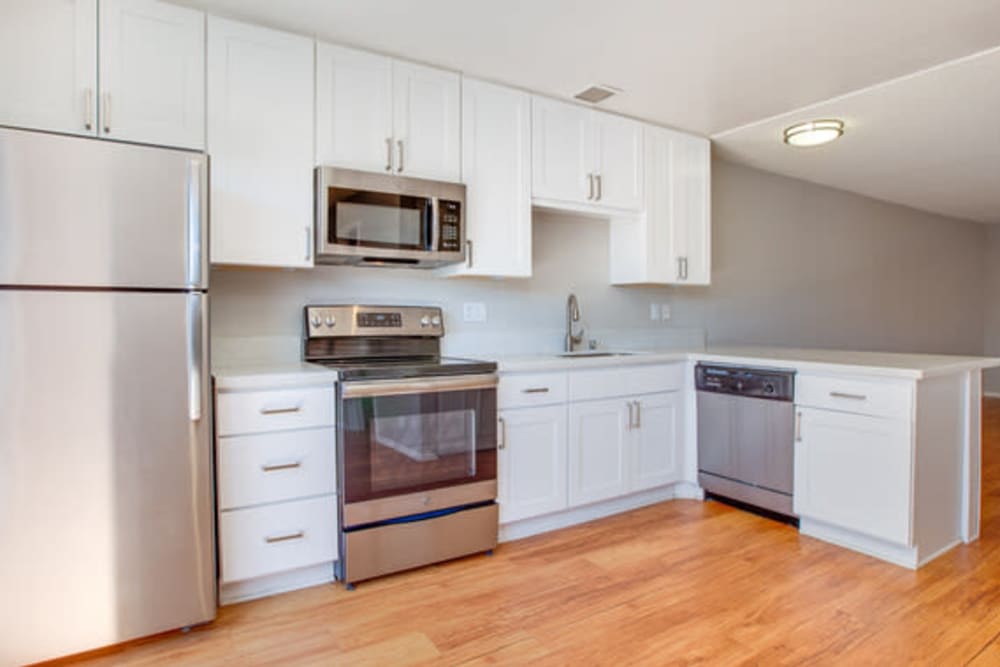 Stainless steel appliances and light wood flooring at Terra Camarillo in Camarillo, California
