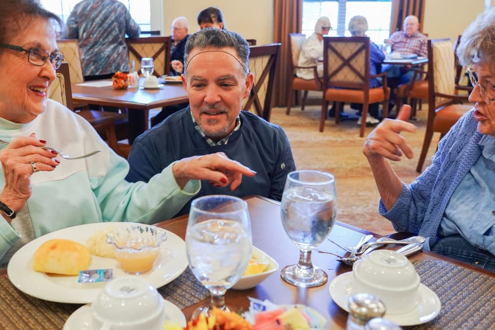 Chef talking with residents in the dining room at Harmony at West Shore in Mechanicsburg, Pennsylvania