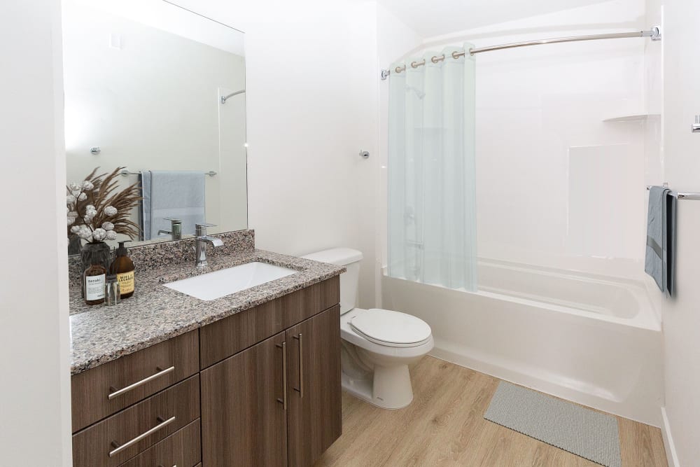 Large bathroom with brown cabinets at The Hardison