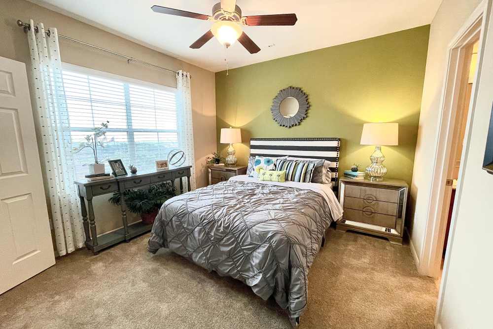 Bedroom with large windows at The Abbey at Stone Oak in San Antonio, TX