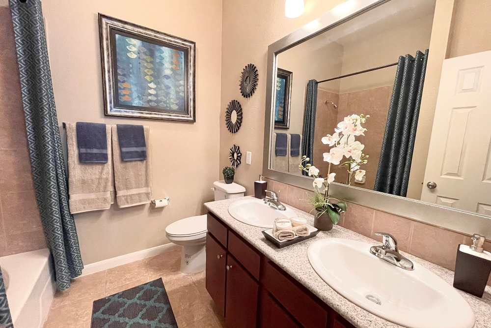 Large bathroom with dual sink at The Abbey at Stone Oak in San Antonio, TX