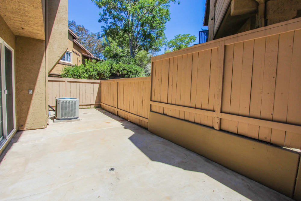 a fenced in rear patio at River Place in Lakeside, California