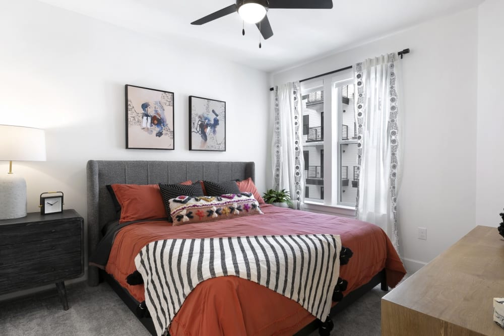 Model bedroom with ceiling fan at The Weaver in Austin, Texas