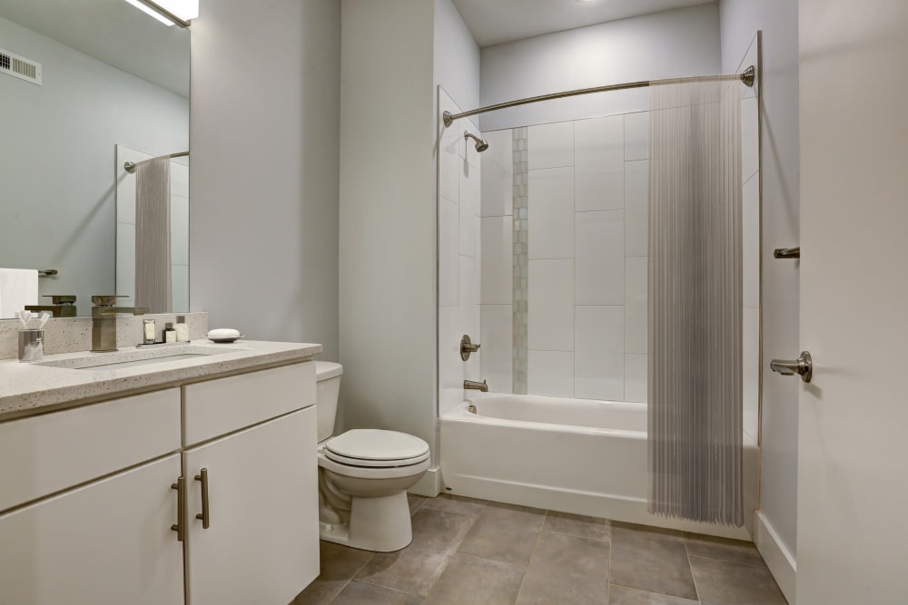 Full-sized bathroom with granite countertops at The 805W Lofts in Richmond, Virginia