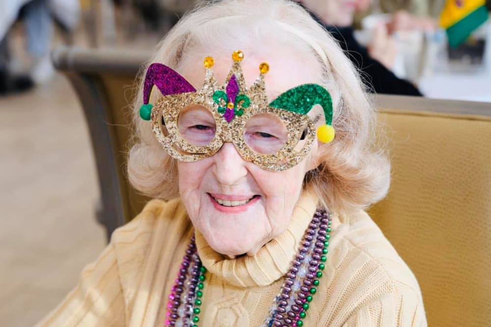 Resident wearing festive glasses during an event at The Blake at Charlottesville in Charlottesville, Virginia