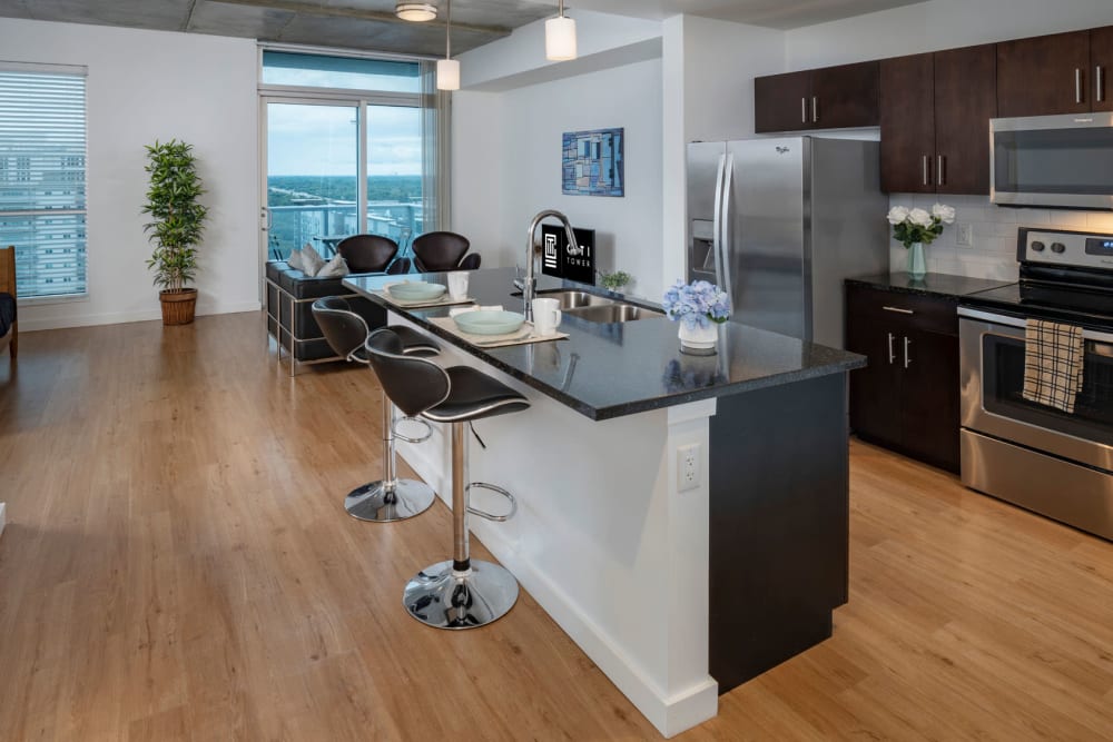 Bar seating at a model home's kitchen island with quartz countertops at CitiTower in Orlando, Florida