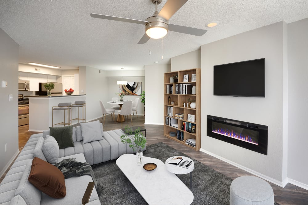 A model living room with fireplace at Altitude Westminster in Westminster, Colorado
