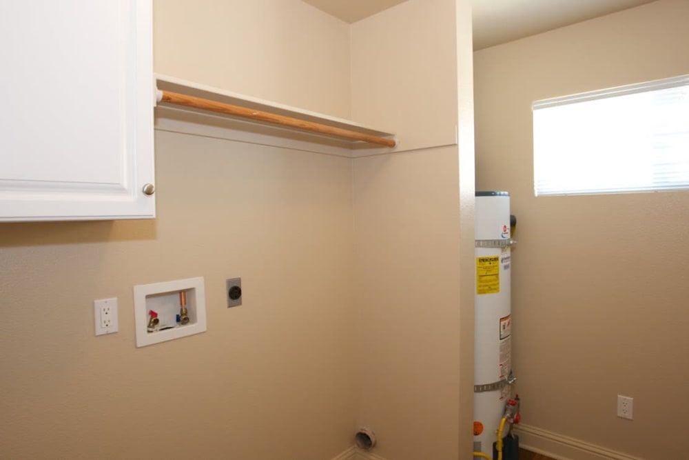 A laundry room with washer and dryer hookups in a home at San Onofre II in San Clemente, California